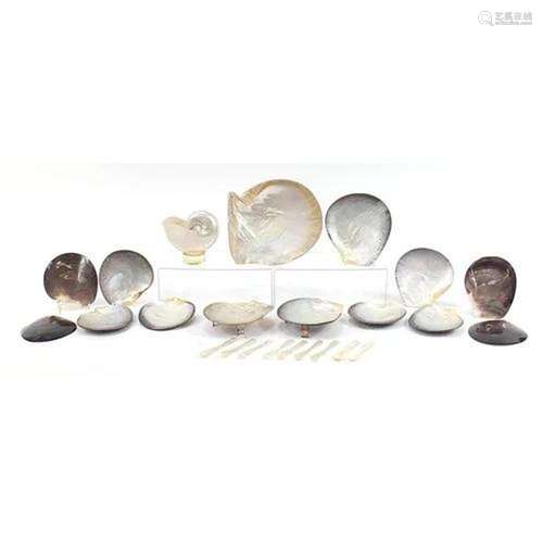 Collection of abalone dishes and spoons, mostly carved with ...