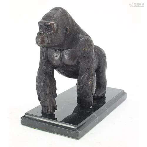 Patinated bronze gorilla raised on a black marble base, 20cm...