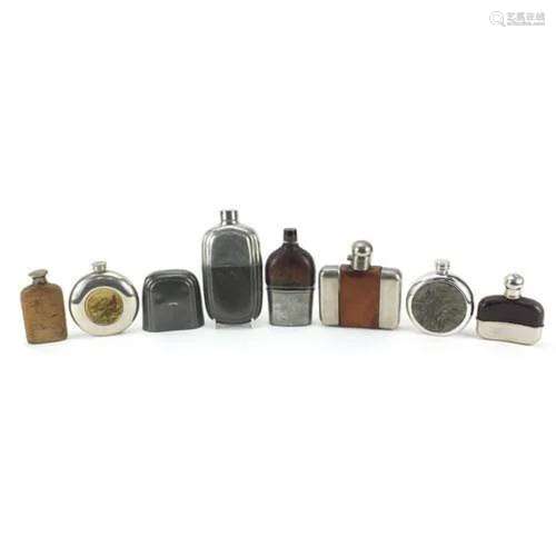 Seven vintage hip flasks, some with leather mounts, the larg...