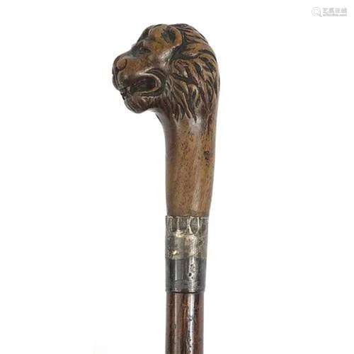 Rosewood walking stick with carved lion head handle and silv...