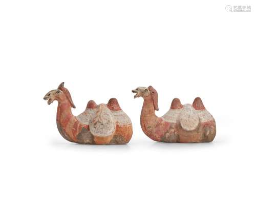 A RARE PAIR OF PAINTED GREY POTTERY FIGURES OF RECUMBENT CAM...