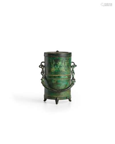 A BRONZE CYLINDRICAL COVERED VESSEL WITH CHAIN HANDLE, ZUN W...