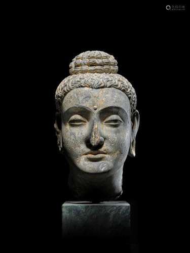 A SCHIST HEAD OF BUDDHA  ANCIENT REGION OF GANDHARA, 3RD/4TH...