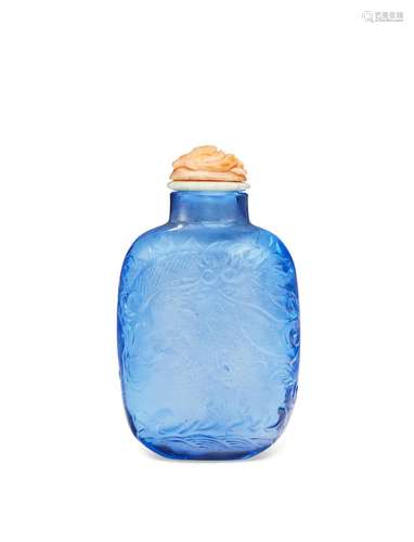 A CARVED PALE-BLUE GLASS SNUFF BOTTLE