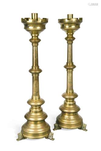 A pair of brass ecclesiastical candle stands,