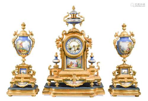 A French gilt metal and porcelain clock garniture, 19th cent...