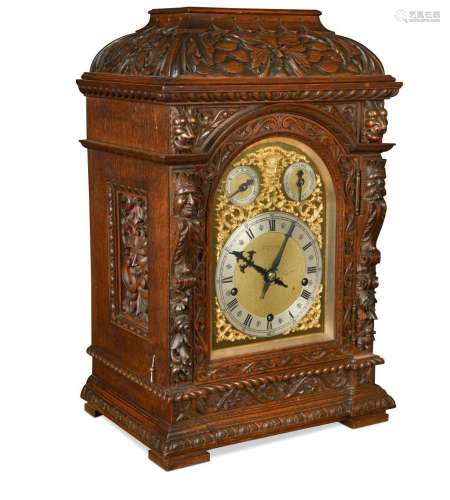 A late Victorian carved oak case chiming mantel clock,