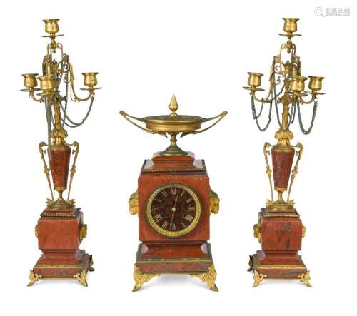 A French red marble and gilt metal garniture de cheminee, 19...