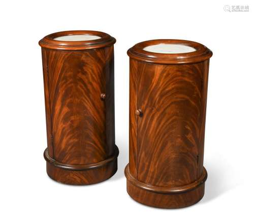 A pair of Victorian figured mahogany cylindrical pot cupboar...