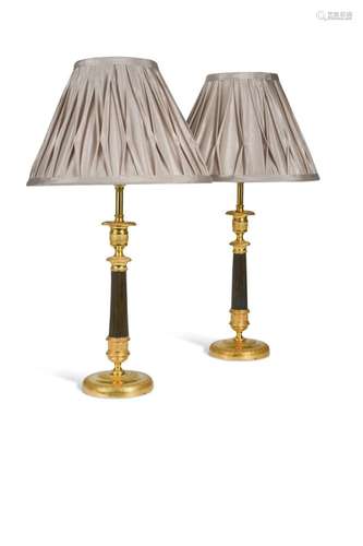 A pair of Regency bronze and gilt bronze candlestick lamps,