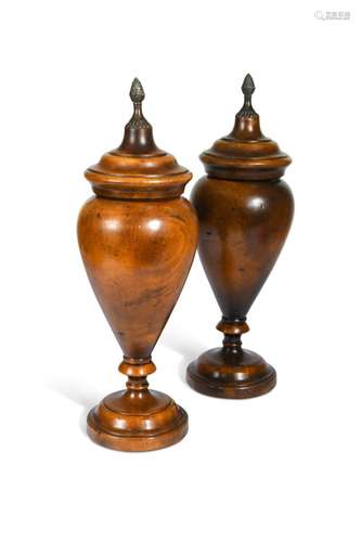 A pair of turned hardwood classical style baluster urns with...