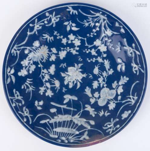 An antique Chinese plate with applied white floral enamel de...