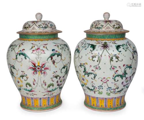 A pair of Chinese porcelain lidded vases with stylized lotus...