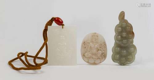 Two carved mutton jade Guanyin ornaments and a carved celado...