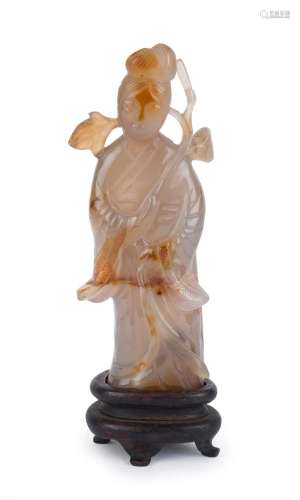 An antique Chinese carved jade statue of a lady holding a br...