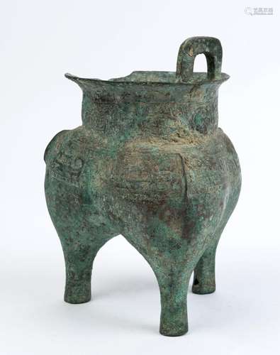 A Chinese archaic style bronze censer resting on three feet,...