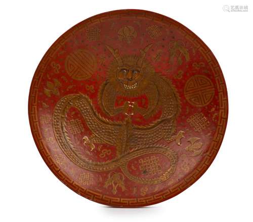 An antique Chinese red lacquered bowl with gilt dragon decor...