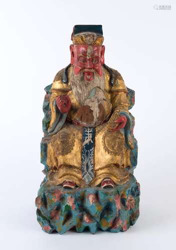 A Chinese statue of a seated man, carved wood with polychrom...