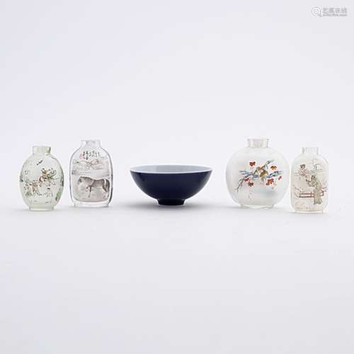 Four Chinese glass snuff bottles and one blue monochrome por...