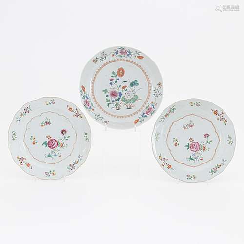 A pair of famille rose plates and a famille rose serving dis...