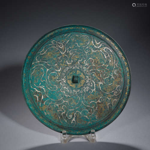 A gold and silver-inlaid bronze mirror, Warring States perio...