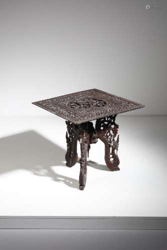 South-Est Asian Art A wooden table carved with foliage and f...