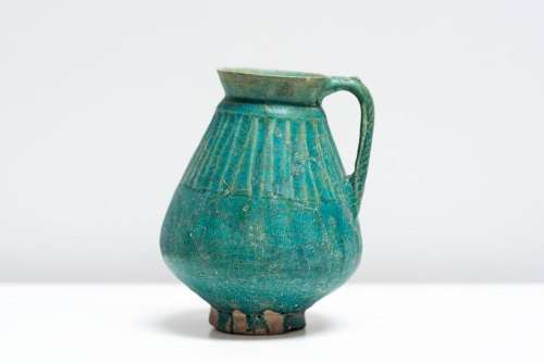 Islamic Art A turquoise glazed pottery jug Iran, 12th-13th c...