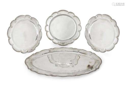 A SHAPED OVAL SERVING PLATTER AND THREE SCALLOPED CIRCULAR P...