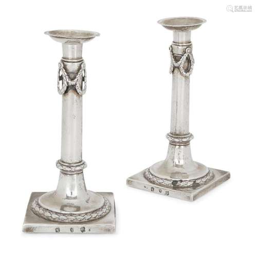 A PAIR OF CONTINENTAL CANDLESTICKS IN THE NEOCLASSICAL STYLE...