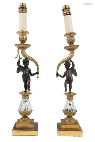 A PAIR OF FRENCH GILT AND PATINATED FIGURAL CANDLESTICKS LAM...