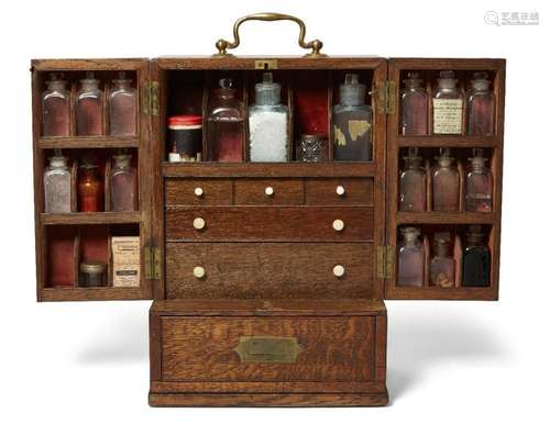 AN OAK APOTHECARY CABINET, 19TH CENTURY, WITH BRASS HANDLES,...