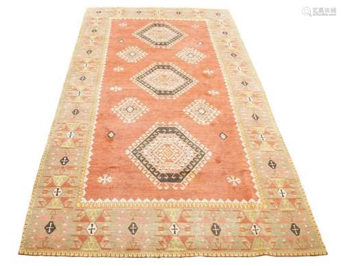 A TURKEY CARPET, LATE 20TH CENTURY, THE FADED BRICK FIELD WI...