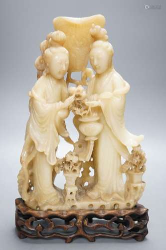 A Chinese soapstone carving of two ladies, wood stand, early...