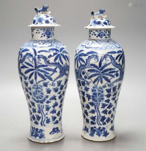 A pair of Chinese blue and white dragon vases and covers, ci...