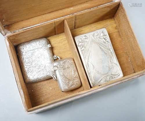 A silver mounted cigarette box, two silver vestas and a silv...