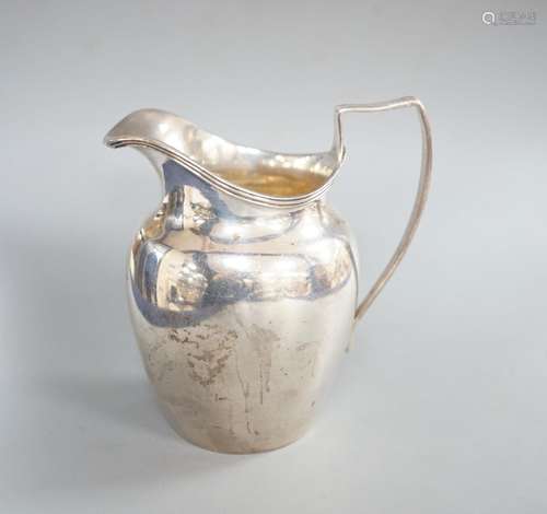 A late Victorian silver helmet shaped cream jug, Birmingham,...