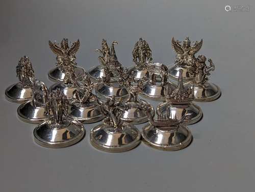 Sixteen assorted Siamese sterling mounted menu holders, mode...