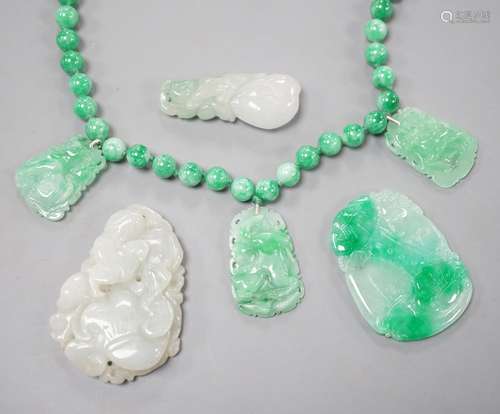 A jade bead necklace hung with three jade carvings, 49cm and...