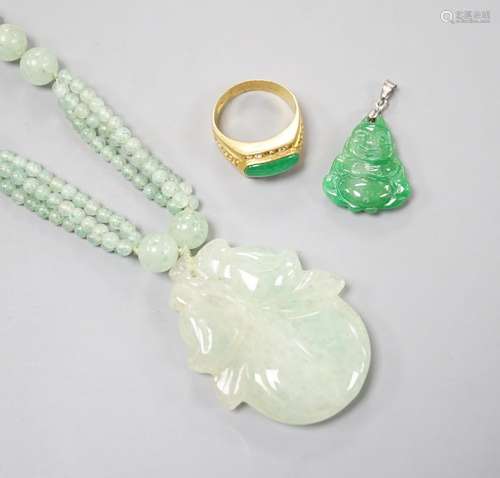 A carved jade pendant, 53mm on a quartz bead necklace, one o...