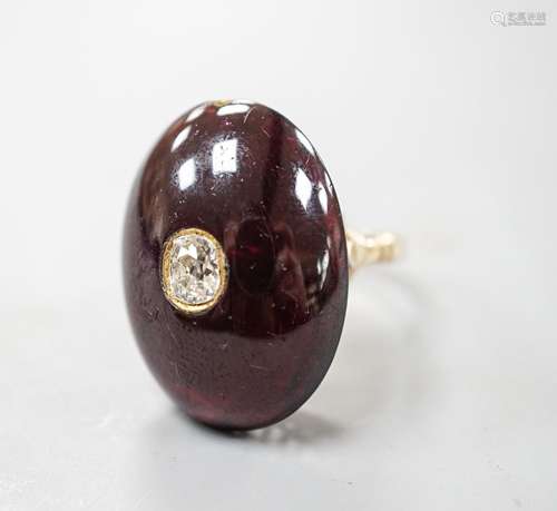 A yellow metal, foil backed cabochon garnet and diamond set ...