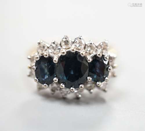 An 18ct and three stone sapphire set ring with diamond set b...