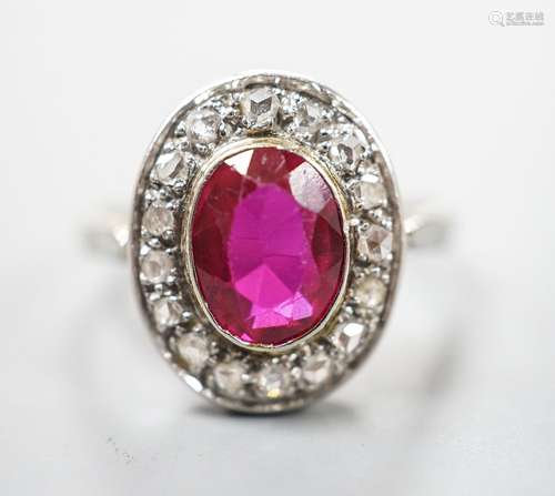 A white metal, synthetic ruby and diamond set oval cluster r...