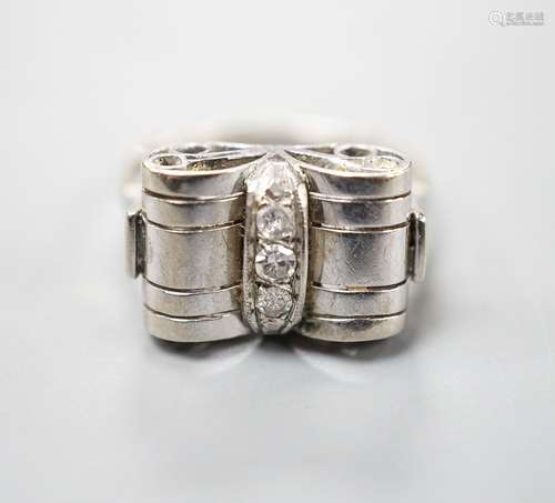 A 1940s white metal and three stone diamond set dress ring, ...