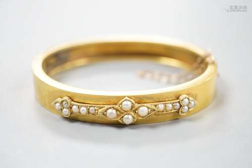 A Victorian yellow metal and split pearl set hinged bangle, ...