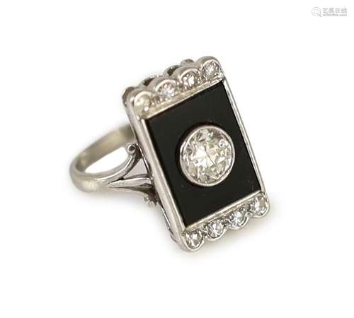 A platinum, single stone diamond and black onyx set rectangu...