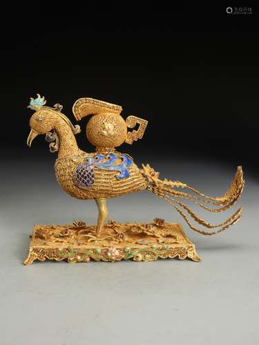 A GILT-BRONZE WITH ENAMEL BIRD ORNAMENT