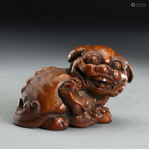 A  LION CARVED BAMBOO ORNAMENT