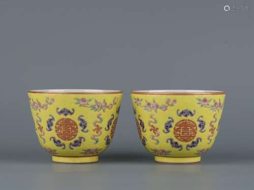 A  TONGZHI PAIR OF YELLOW GROUND FAMILLE ROSE CUPS