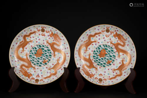 A pair of allite red glazed 'dragon' dish painting in gold