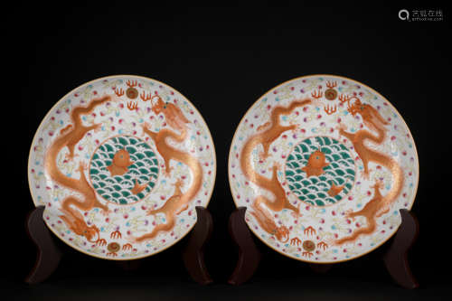 A pair of allite red glazed 'dragon' dish painting in gold